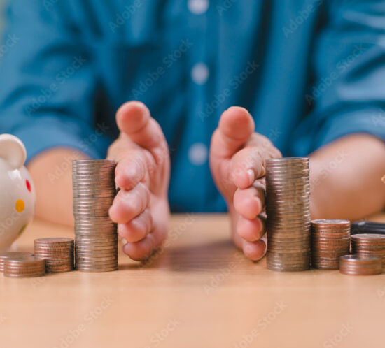Divorce law and heritage separation concept. Hand separate saving money, financial, home loan, debt with piggy bank and wood house. Bank business investment. Man separate stack coin on table